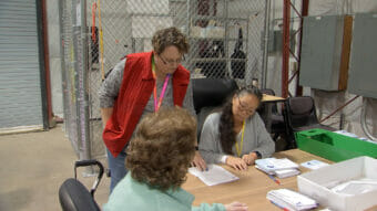 City Clerk Beth McEwen supervises workers at the Juneau ballot processing center on Monday October 2nd, 2023. (Photo by Mikko Wilson/KTOO)