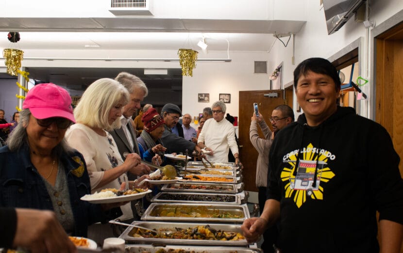 Mga Kuwento. People line up for food from various Filipino restaurants.