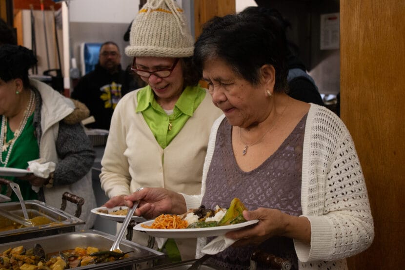 Mga Kuwento. Elders fill their plates.