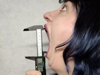 Ketchikan resident Marie Pearl Zellmer Robinson measures her mouth with a pair of digital calipers.
