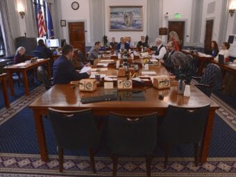 a committee room with legislators and staff