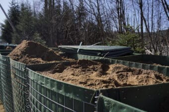 HESCO barriers partially built along Riverside Drive on April 2, 2025. (Photo by Alix Soliman/KTOO)