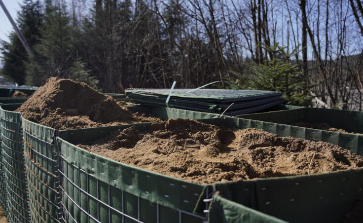 HESCO barriers partially built along Riverside Drive on April 2, 2025. (Photo by Alix Soliman/KTOO)