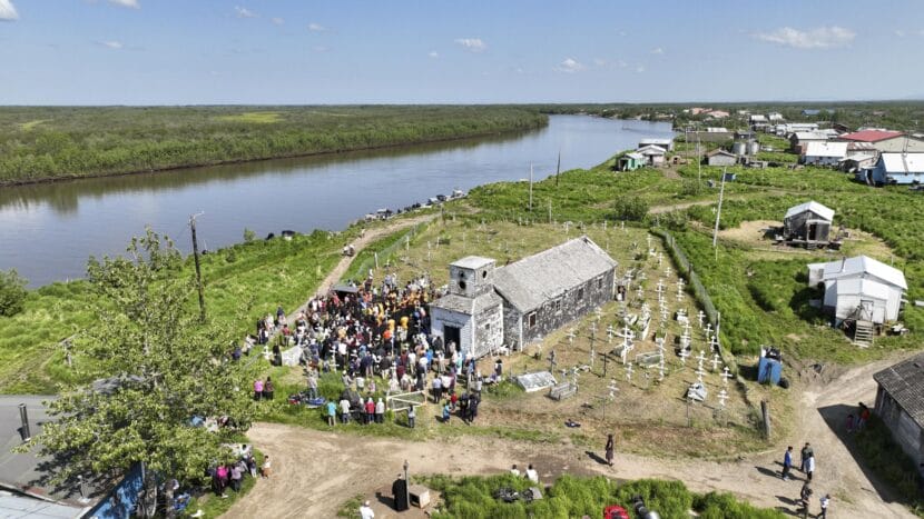 Orthodox pilgrims and clergy gather in the old St. Nicholas Russian Orthodox Church cemetery to take part in the glorification ceremony for St. Olga in Kwethluk on June 19, 2025.