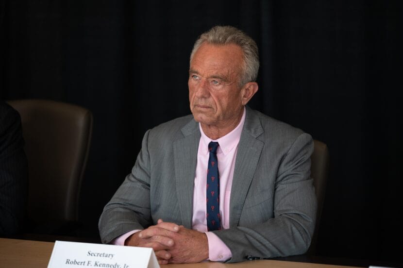 A man in a suit attends a press briefing