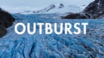 an aerial view of a blue glacier with the words outburst across it