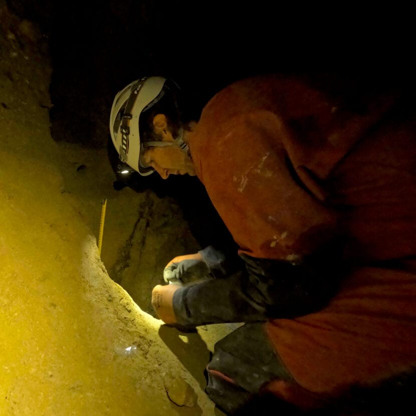 Paul Wilcox samples Siku sediments inside Devil's Canopy Cave. (Photo courtesy of Jessica Honkonen). 