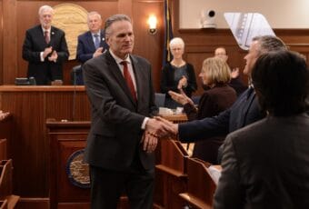 Alaska Gov. Mike Dunleavy shakes hands with Rep. Andrew Gray, D-Anchorage, following the annual State of the State address on Tuesday, Jan. 28, 2025, in the Alaska Capitol.