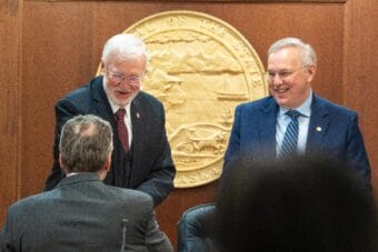 Senate President Gary Stevens, R-Kodiak, greets Gov. Mike Dunleavy while standing alongside House Speaker Bryce Edgmon, I-Dillingham, in the House chamber at the Alaska State Capitol in Juneau on Jan. 28, 2025.