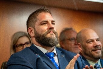 Adam Crum, then the commissioner of the Alaska Department of Revenue, applauds during Gov. Mike Dunleavy's State of the State Address at the Alaska State Capitol in Juneau on Jan. 30, 2024.