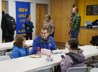 Chad Millen has lunch with his daughters at the IBEW building on Thursday, October 16, 2025. (Photo by Alix Soliman/KTOO)