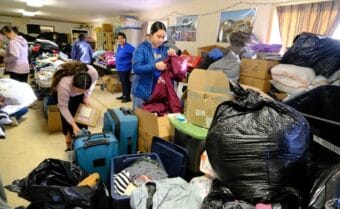 Volunteers and evacuees from villages impacted by the ex-typhoon Halong sort through donations at the Bethel Search and Rescue building on Oct. 14, 2025.
