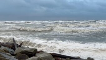 Waves crashing on a beach fortified with rip-rap