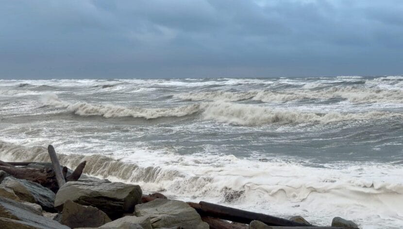 Waves crashing on a beach fortified with rip-rap
