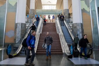 Passengers arrive at the Ted Stevens Anchorage International Airport on April 20, 2022, a day after masks became optional on flights. (Jeff Chen/Alaska Public Media)