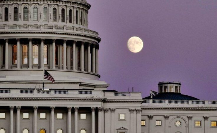 moonrise over Capitol, with dome to the left and purple sky.