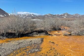 A tributary of the Kugororuk River in northwest Alaska runs orange.