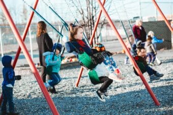 Students swing on a playground at Meadow Lakes Head Start in Wasilla, Alaska. It closed in 2024 due to funding and staffing challenges.