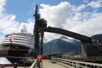 The Disney Wonder cruise ship docks near the ship loader at Skagway's ore terminal.