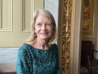 woman in green, in an ornate room