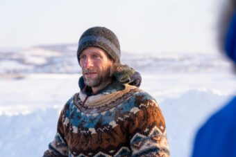 A musher standing in sunshine