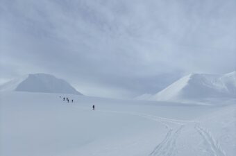 A small group of backcountry skiers ascend a slope near Haines Pass in January, 2026.