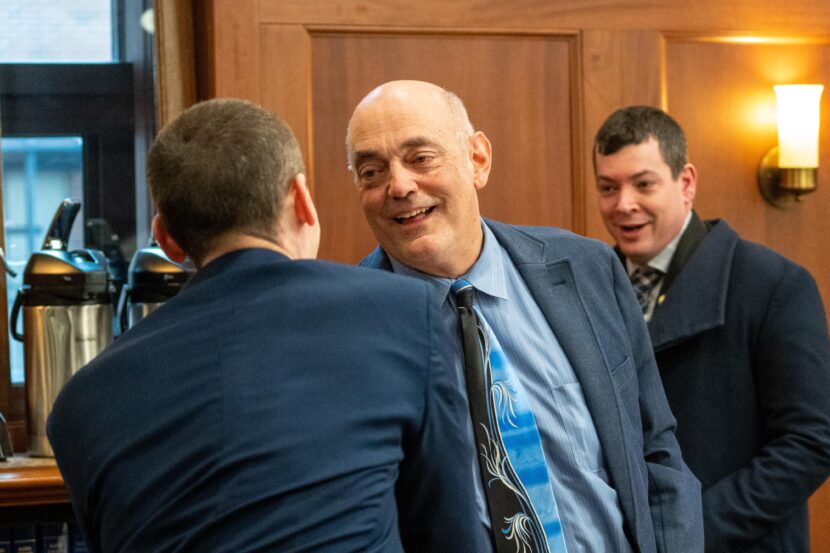 Legislators congratulate Rep. Andy Josephson, an Anchorage Democrat who co-chairs the House Finance Committee, after the House passed its version of the state operating budget on April 13, 2026.