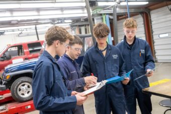 Students talk with a teacher during a diesel technical class in UAS Dual Enrollment Program.