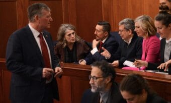 At left, House Majority Leader Chuck Kopp, R-Anchorage, talks with experts on the proposed trans-Alaska natural gas pipeline during a break in debates Monday, May 18, 2026. To Kopp's immediate right is Joelle Hall of the Alaska AFL-CIO. At center, gesturing, is former U.S. Sen. Mark Begich, now an adviser to Gov. Mike Dunleavy.