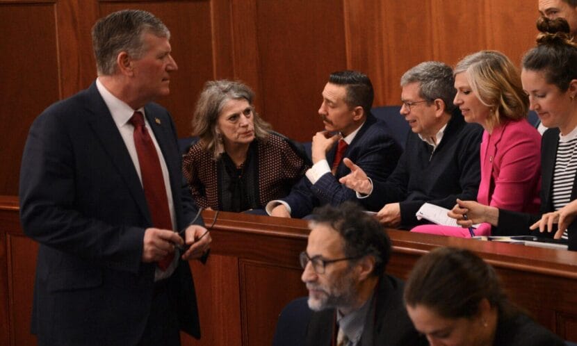 At left, House Majority Leader Chuck Kopp, R-Anchorage, talks with experts on the proposed trans-Alaska natural gas pipeline during a break in debates Monday, May 18, 2026. To Kopp's immediate right is Joelle Hall of the Alaska AFL-CIO. At center, gesturing, is former U.S. Sen. Mark Begich, now an adviser to Gov. Mike Dunleavy.