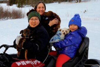 Executive Director of Alaska Native Rural Veterinary Angie Fitch (middle), Koyuk residents and their pets during a veterinary visit.