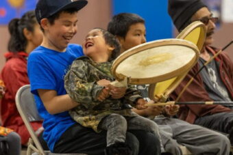 Young drummers from the Kingikmiut Dance Group wait to perform at the 25th Annual Kingikmiut Dance Festival.