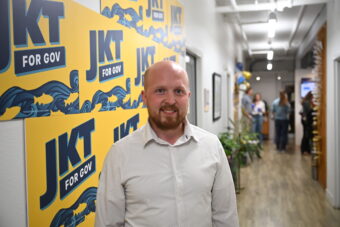 Jonathan Kreiss-Tomkins poses at his primary election night party the The Rail in Anchorage on Aug. 18, 2026.