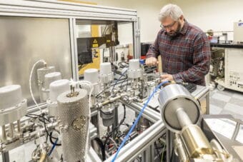 UAF geochronologist Florian Hoffman works on the program’s argon mass spectrometer.