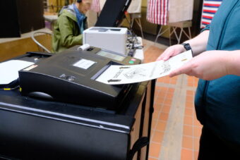 A voter casts their ballot on the first day of early in person voting in Juneau on Oct. 19, 2026.