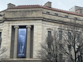 A banner showing President Donald Trump hangs on the Department of Justice on Feb. 20, 2026.